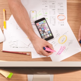 design sketches spread out on tabletop