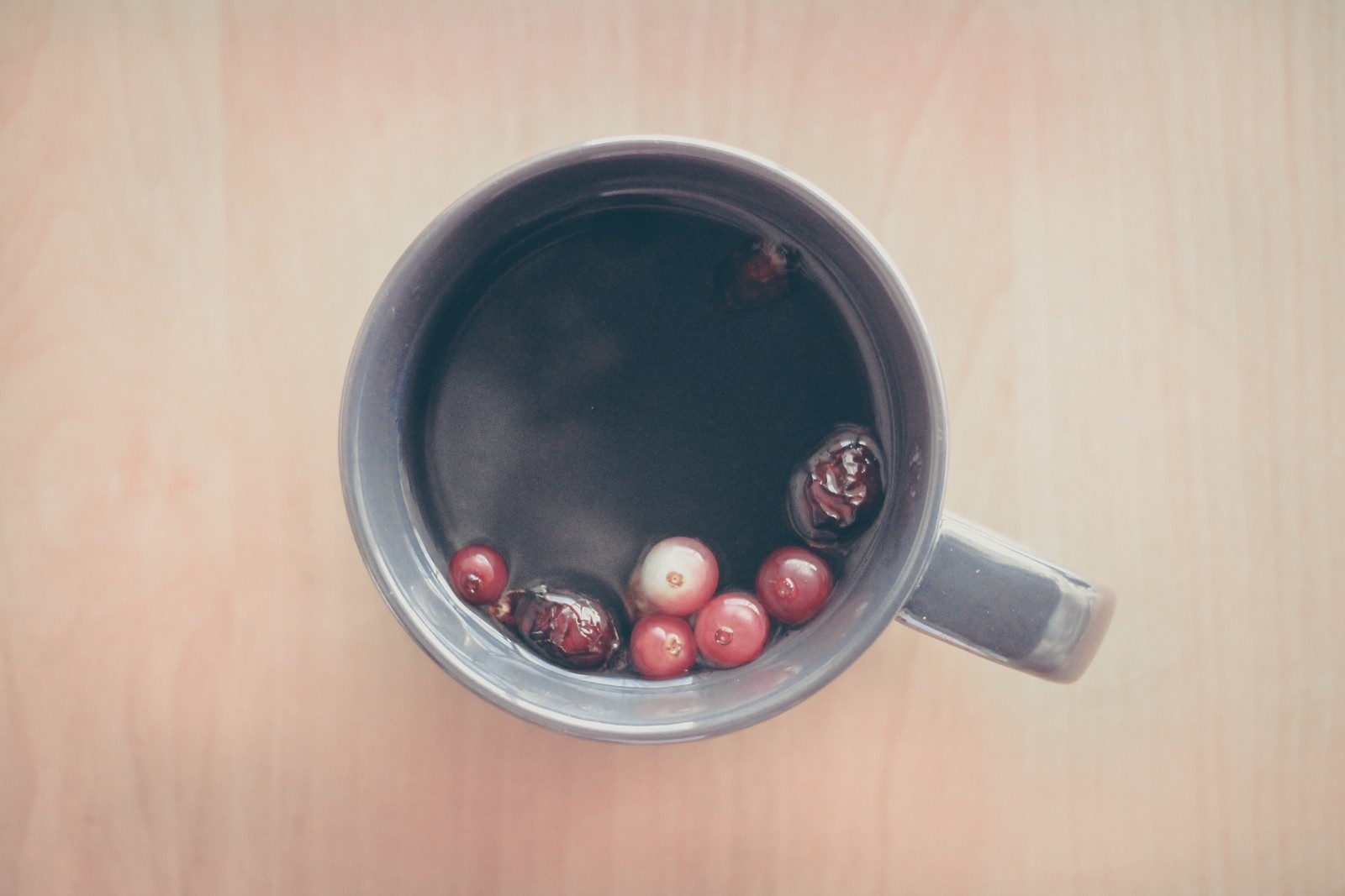 image of berries floating in tea