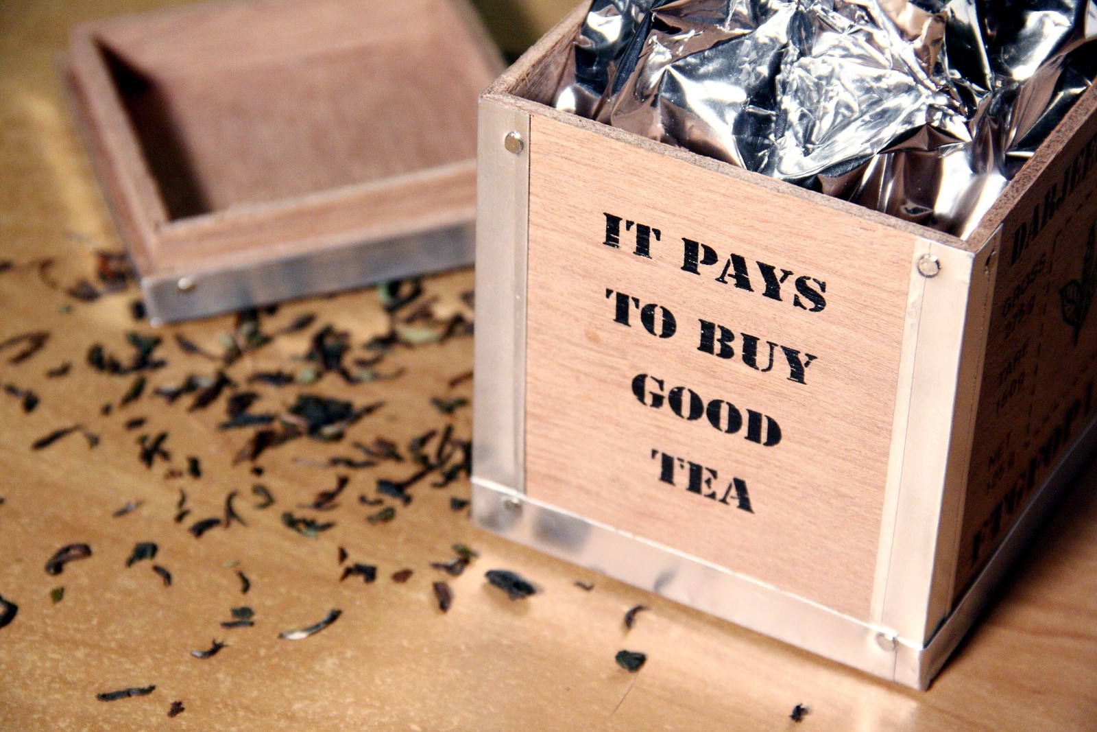 image of wooden box with printed black lettering, it pays to buy good tea